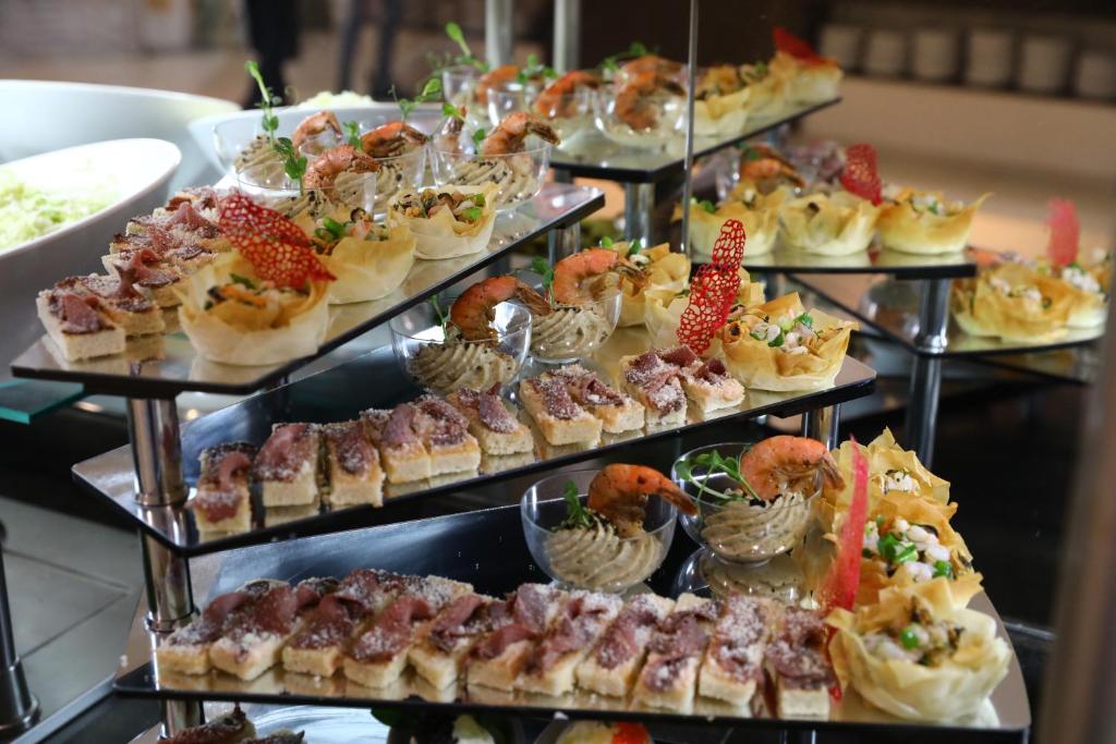 a display of desserts and pastries on a buffet at Arena Mar Hotel and SPA in Golden Sands