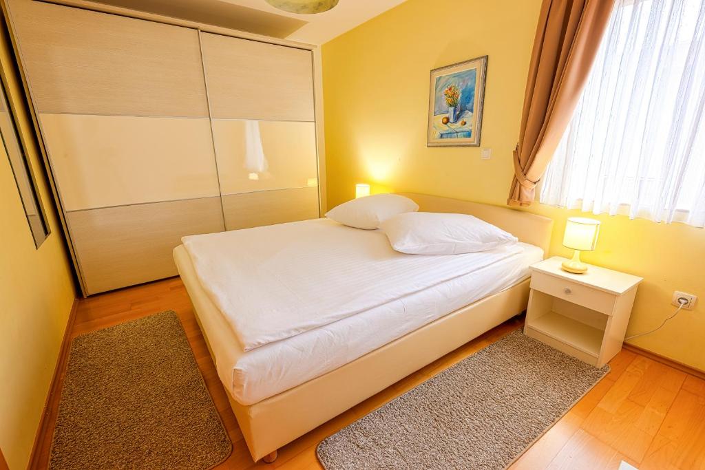 Postel nebo postele na pokoji v ubytování Apartmani Maltar