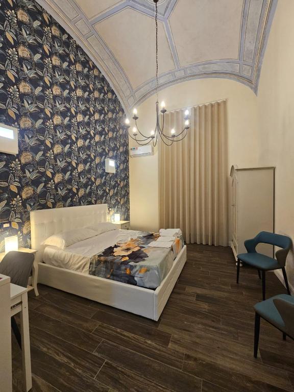 a bedroom with a bed in a room with a ceiling at Napoli the charme in Naples