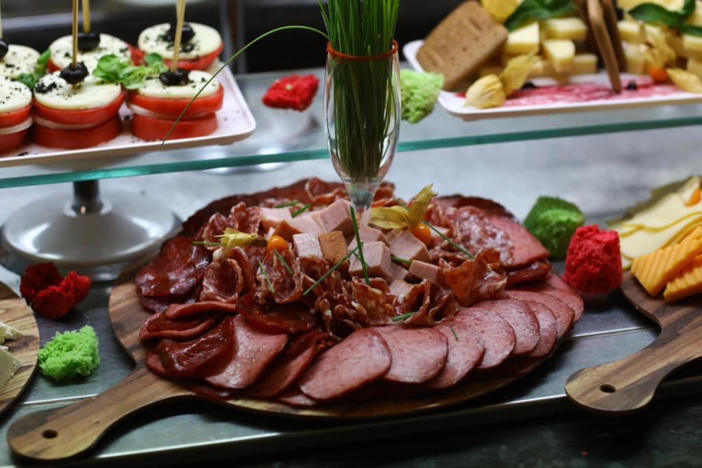 a plate of food with meat and other desserts at Arena Mar Hotel and SPA in Golden Sands