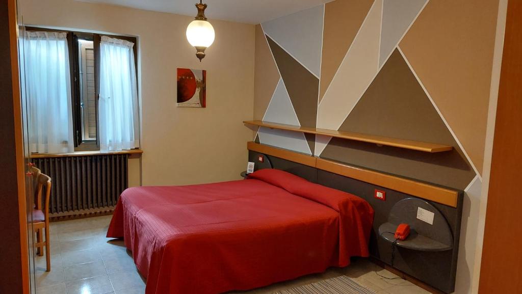 Postel nebo postele na pokoji v ubytování Hotel La Lanterna