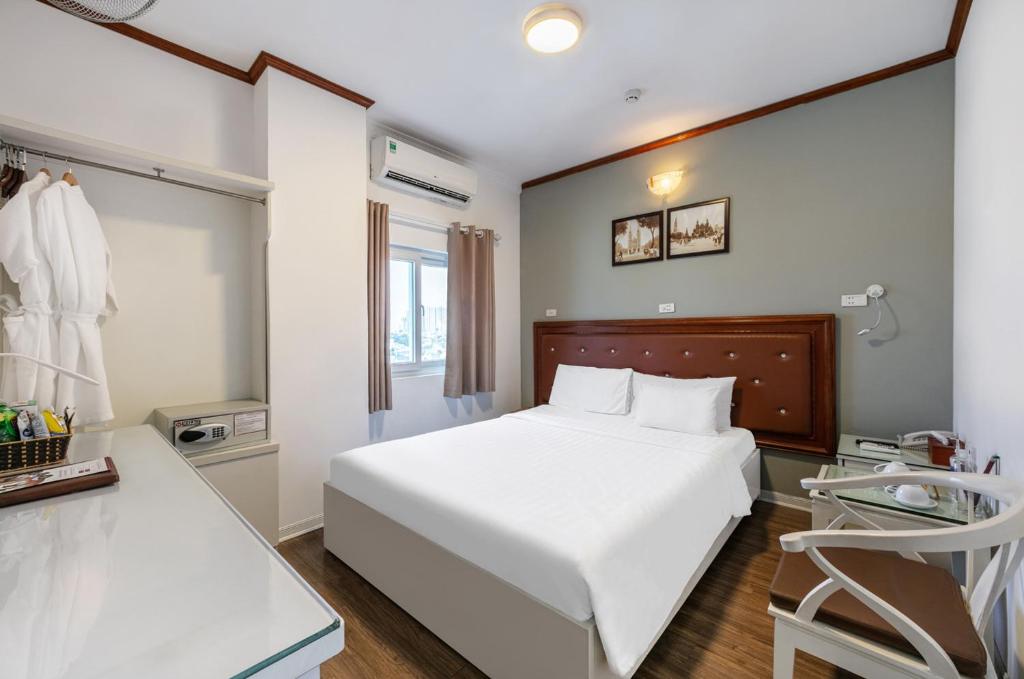 Postel nebo postele na pokoji v ubytování A25 Hotel - 185 Lò Đúc