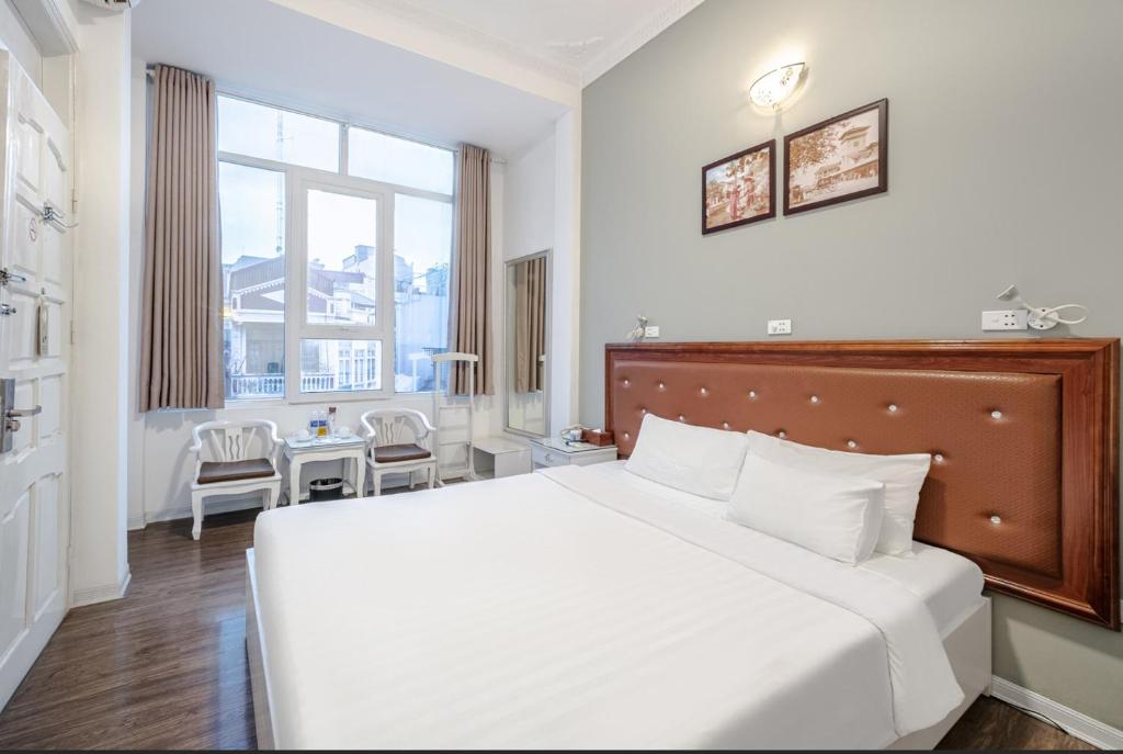 Postel nebo postele na pokoji v ubytování A25 Hotel - 185 Lò Đúc