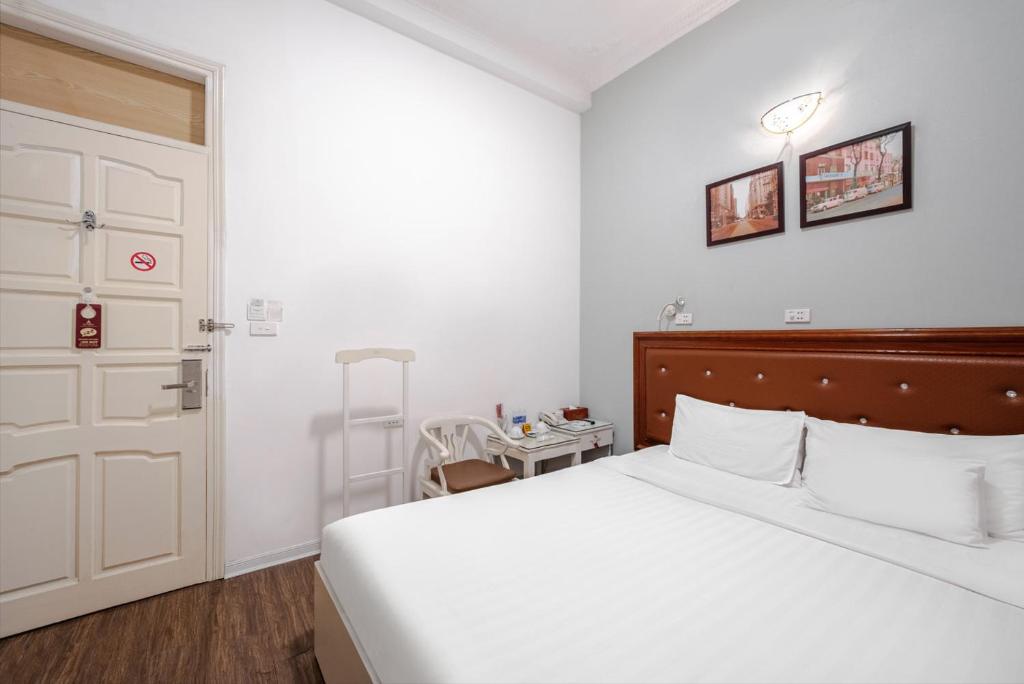 Postel nebo postele na pokoji v ubytování A25 Hotel - 185 Lò Đúc