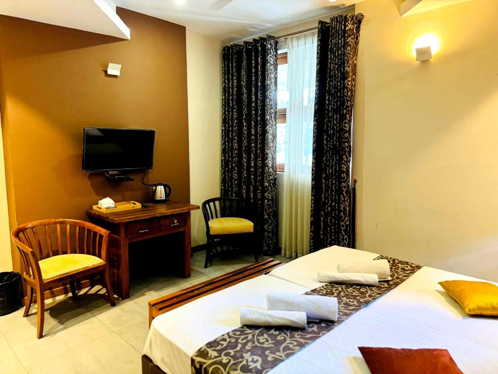 Postel nebo postele na pokoji v ubytování Rivorich Residence Kandy