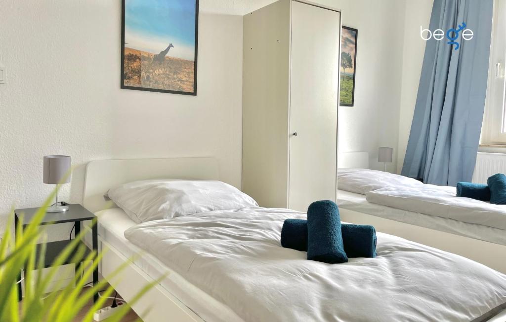 een slaapkamer met twee bedden en een spiegel bij BEGE APARTMENTS WorkStay Lodge in Essen