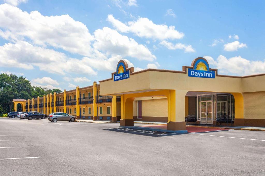 a yellow building with a sign for a dental office at Days Inn by Wyndham Shelby in Shelby