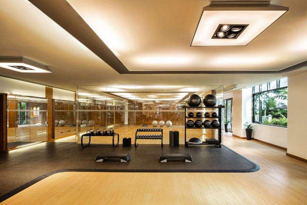 a large room with a yoga room with a black rug at Conrad Bangkok in Bangkok