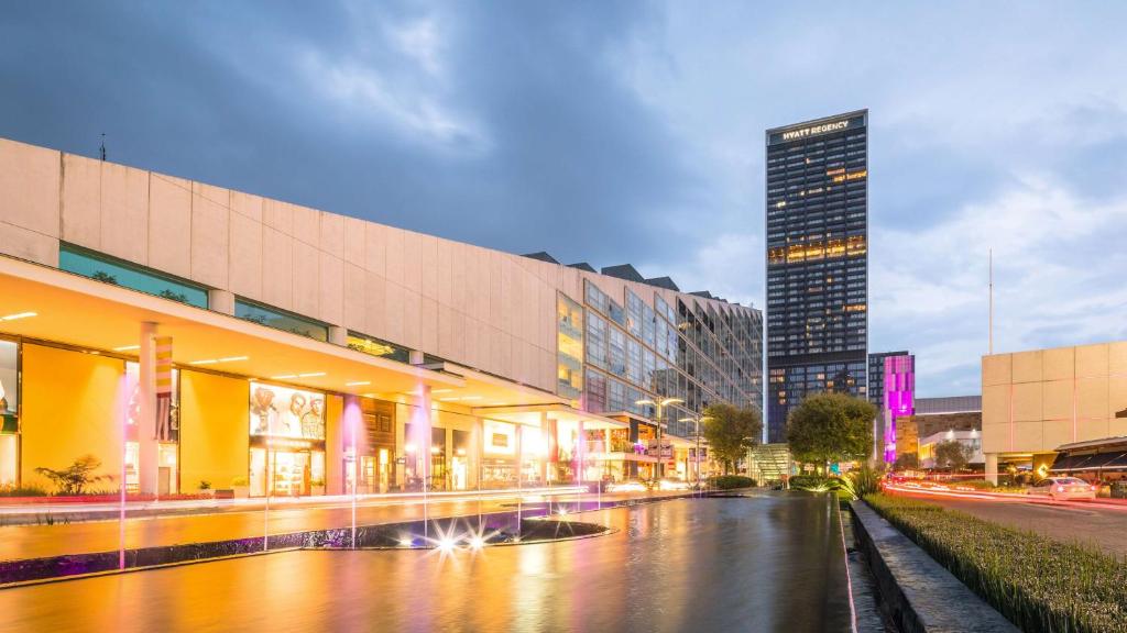 a city street with buildings and a tall building at Hyatt Regency Andares Guadalajara in Guadalajara