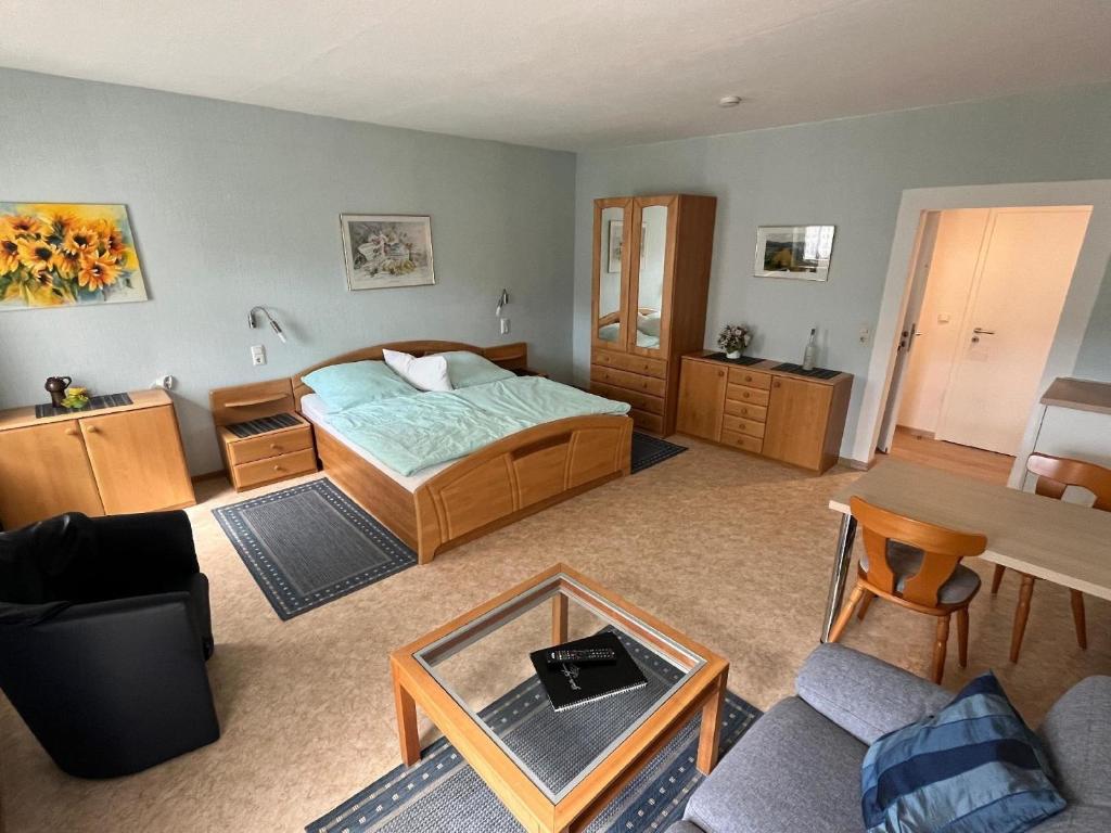 a bedroom with a bed and a table in it at Haus Budinger in Alf