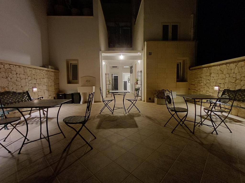 a group of tables and chairs in a room at Dimora Carafa apartment in Lecce