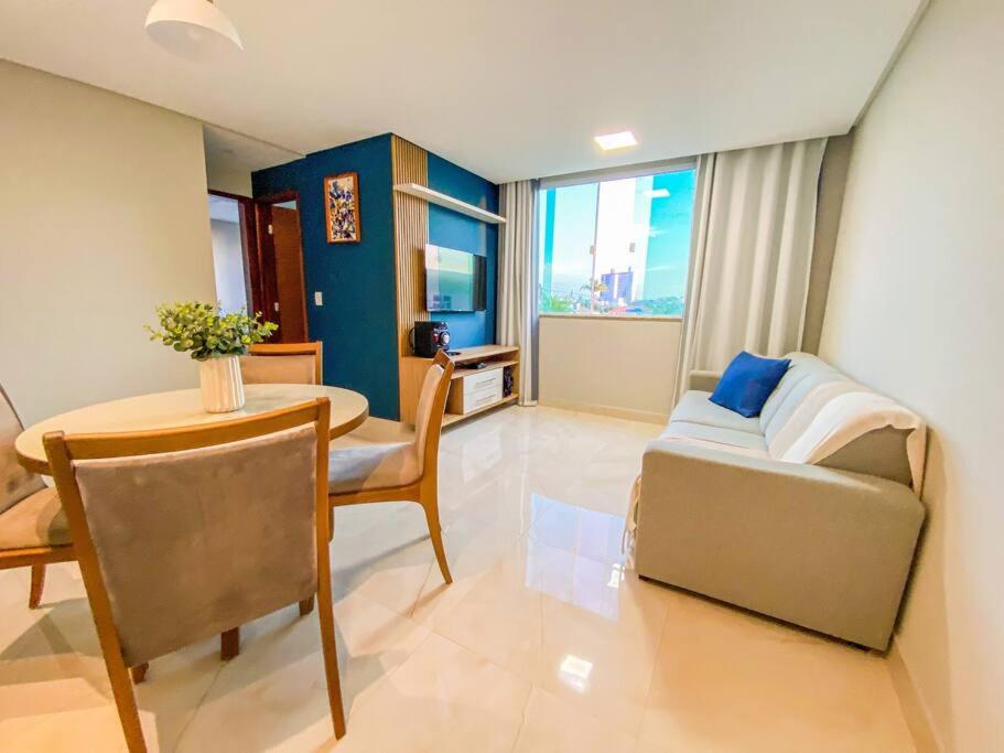 a living room with a couch and a table at Ap 2 quartos espaçoso in Natal