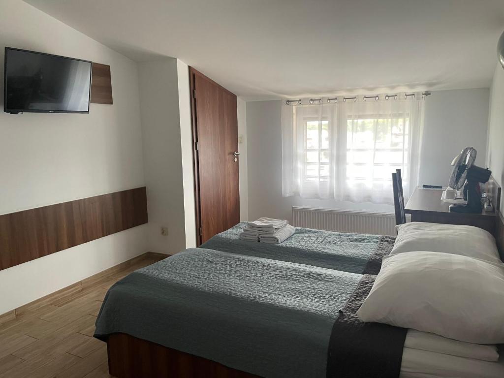 Postel nebo postele na pokoji v ubytování Posejdon Pokoje Gościnne