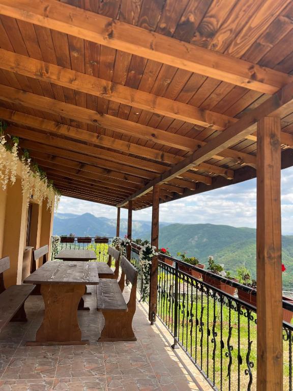 a wooden pergola with a picnic table on a patio at Villa Garden in Kremen