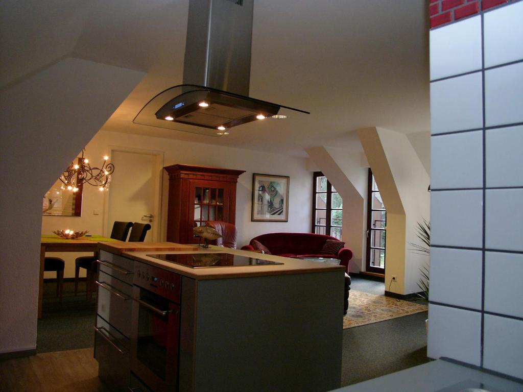 a kitchen with a sink and a living room at Ferienwohnung Am Dom in Xanten