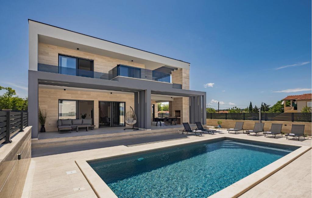 a house with a swimming pool in front of it at Awesome Home In Nin With House Sea View in Nin