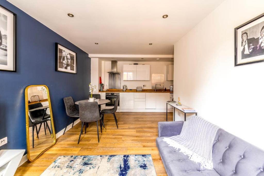 a living room with a couch and a table at Contemporary Abbey Yard by Prescott Apartments in Abingdon