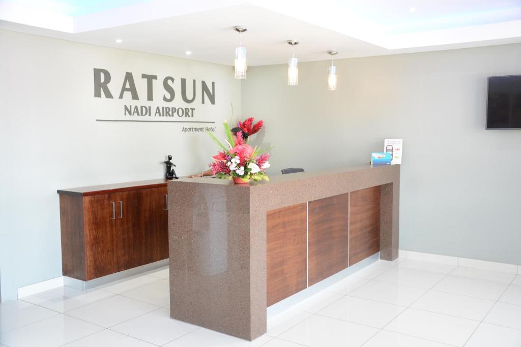 a reception desk in a room with a sign that reads raisin mobil airport at Ratsun Nadi Airport Apartment Hotel in Nadi
