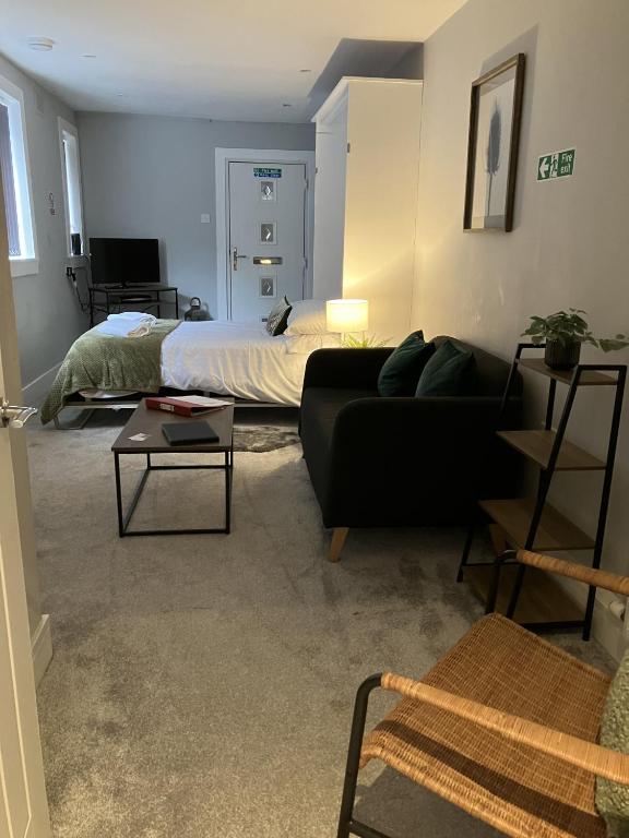 a living room with a couch and a bed at Teviot View in Hawick
