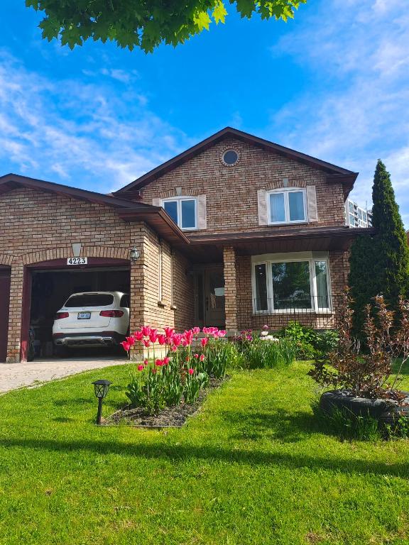 a house with a car parked in the driveway at Tom oker in Mississauga