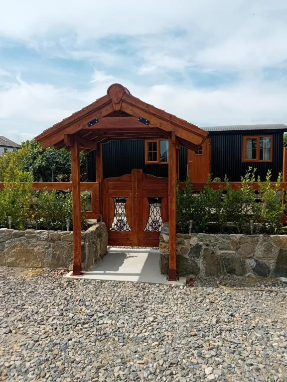 a wooden gazebo in front of a house at Carlingford Glamping Hut in Rathcor Lower