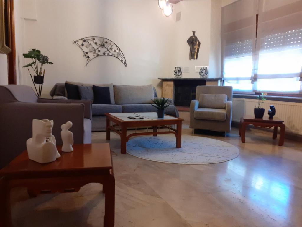 a living room with couches and chairs and a table at GUSTO Apartment 2 in Orestiada