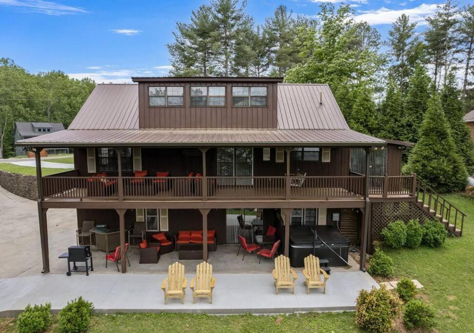 a large house with a deck and chairs at Reflection Bay in Winchester