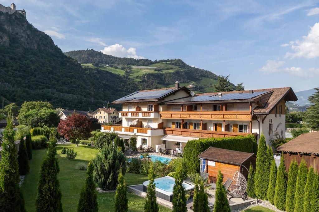 a villa with a swimming pool and a resort at Hotel Bischofhof - Bistro Jasmin in Chiusa