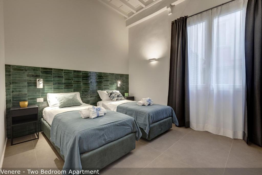 Posteľ alebo postele v izbe v ubytovaní Venere & Zefiro Apartments by Mamo Florence