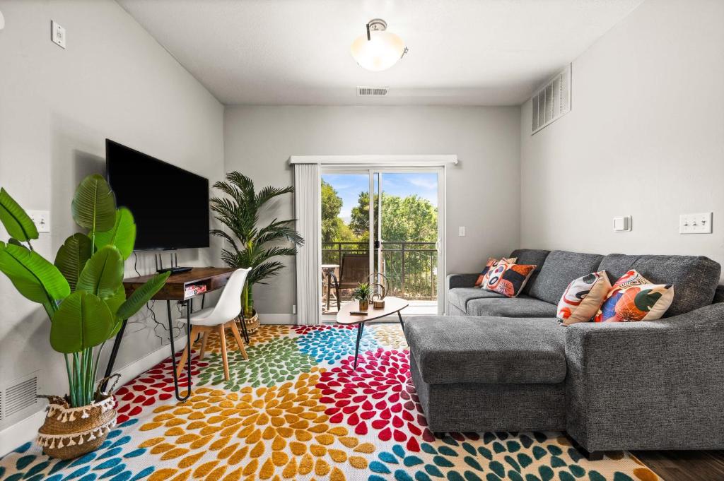 a living room with a couch and a tv at Stylish Apartment Close to Attractions in Salt Lake City