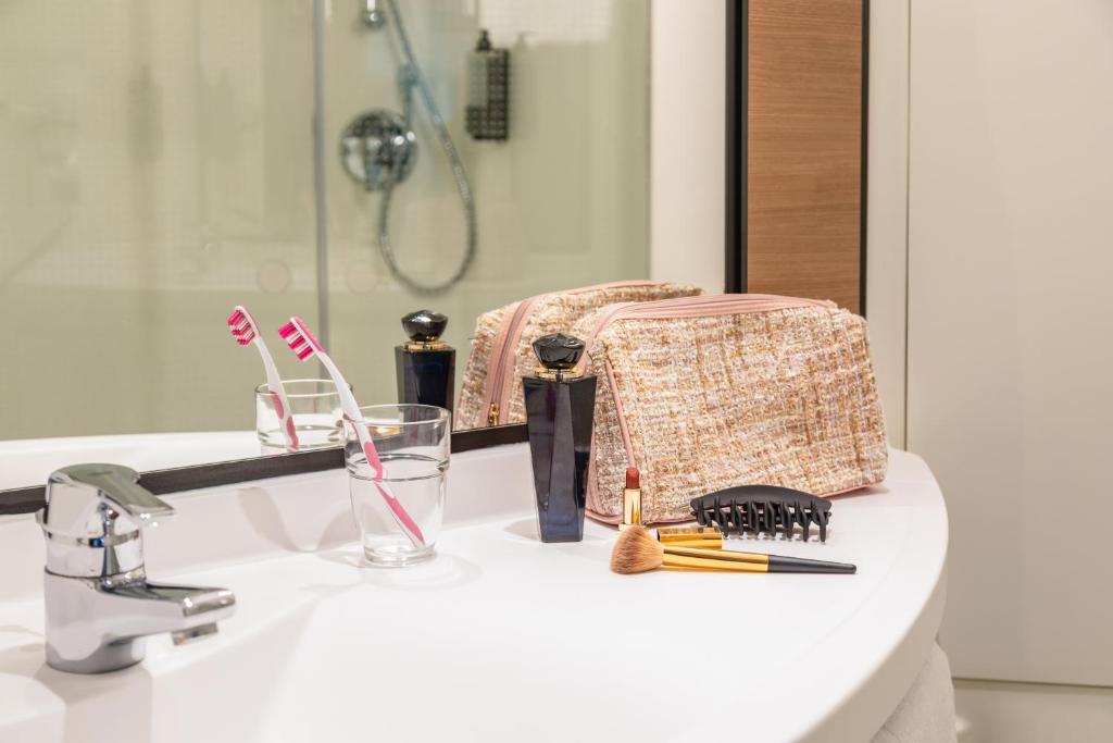 a bathroom sink with toothbrushes and a mirror at ibis Hotel Dortmund City in Dortmund