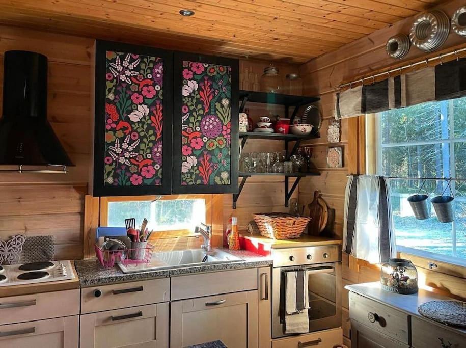 a kitchen with a sink and a counter top at Tunnelmallinen ilmastoitu järvenrantahuvila in Saarijärvi