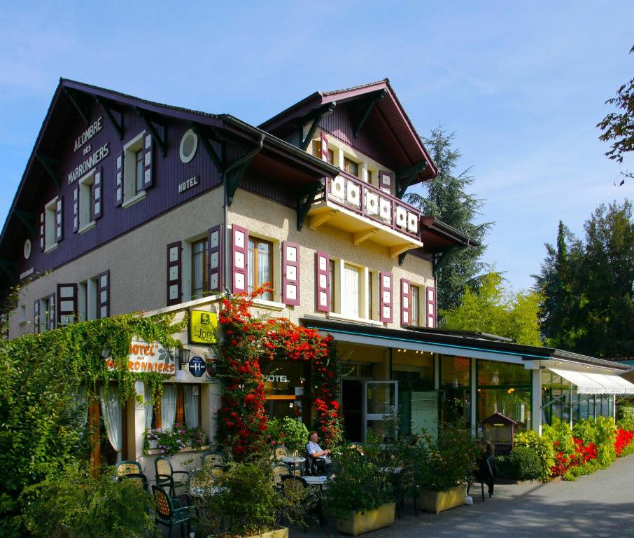 a large building with flowers in front of it at HOTEL LES MARRONNIERS in Thonon-les-Bains