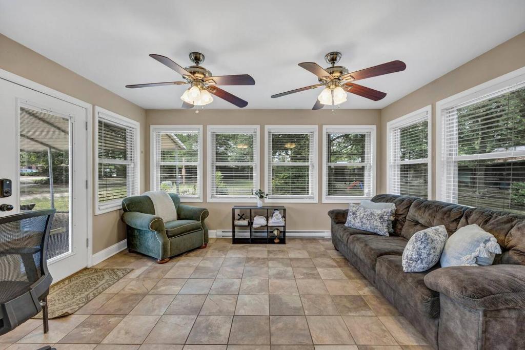 a living room with a couch and a fan at Hamilton Home Playground 2BR in Lexington
