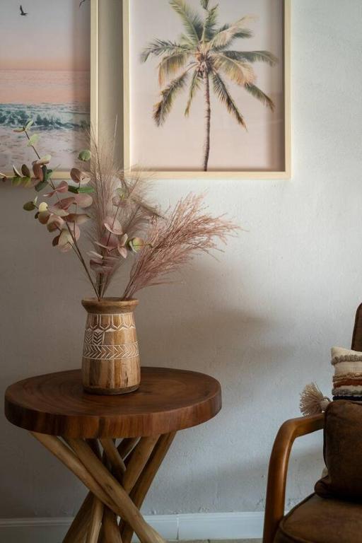 a wooden table with a vase on top of it at Ocean Home Sweet Home - Suite 1 in Rosarito