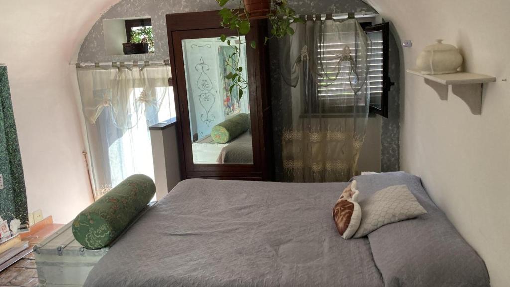 a bedroom with a bed and a large mirror at Casa Guardiola 2 in Pacentro