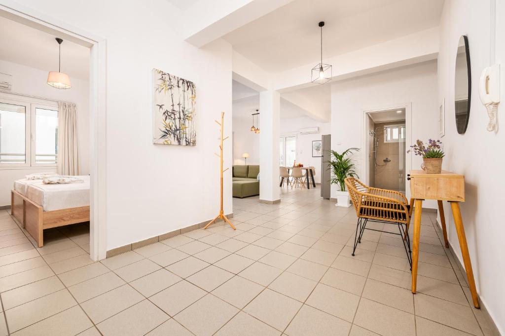 a room with a bed and a table and a chair at Modern Apartment in the heart of Kos Town in Kos Town