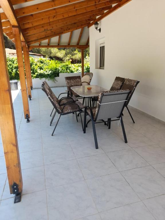 a patio with a table and chairs on a patio at Dimitra House in Metamorfosi