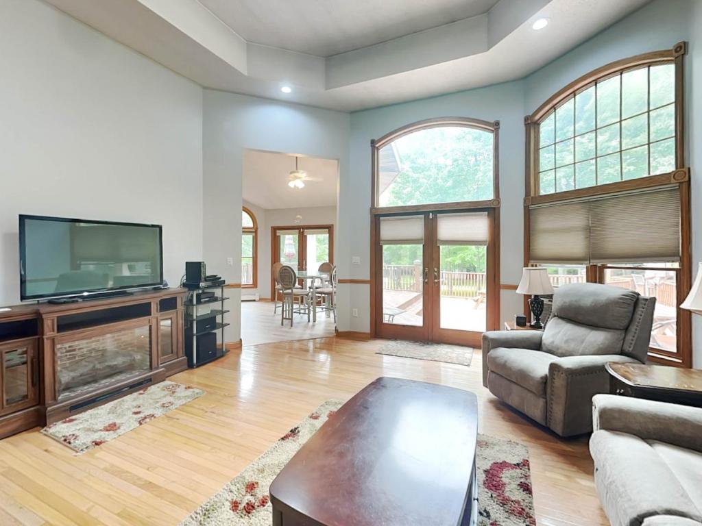 a living room with a tv and a couch and a table at Beautiful Adventure in Oakland