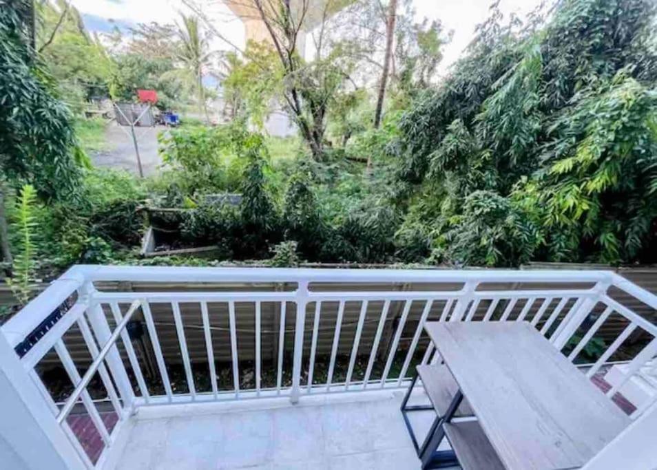a balcony with a bench and a table at 1BR By The Airport at Amani Grand Residences in Lapu Lapu City