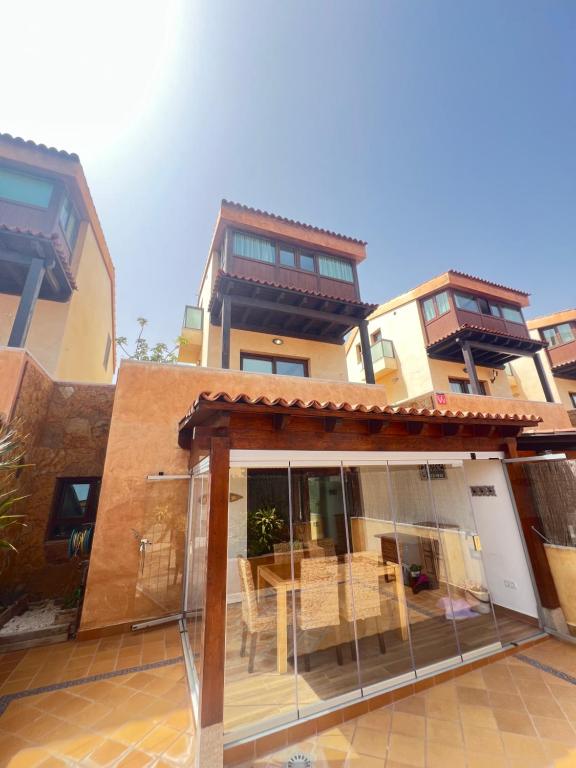 a building with a patio with a table in it at Tinajas Penthouse Views in Corralejo