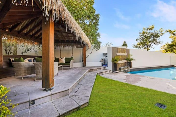 a backyard with a swimming pool and a pavilion at TWELVE at 12 Private Central Maroochydore in Maroochydore
