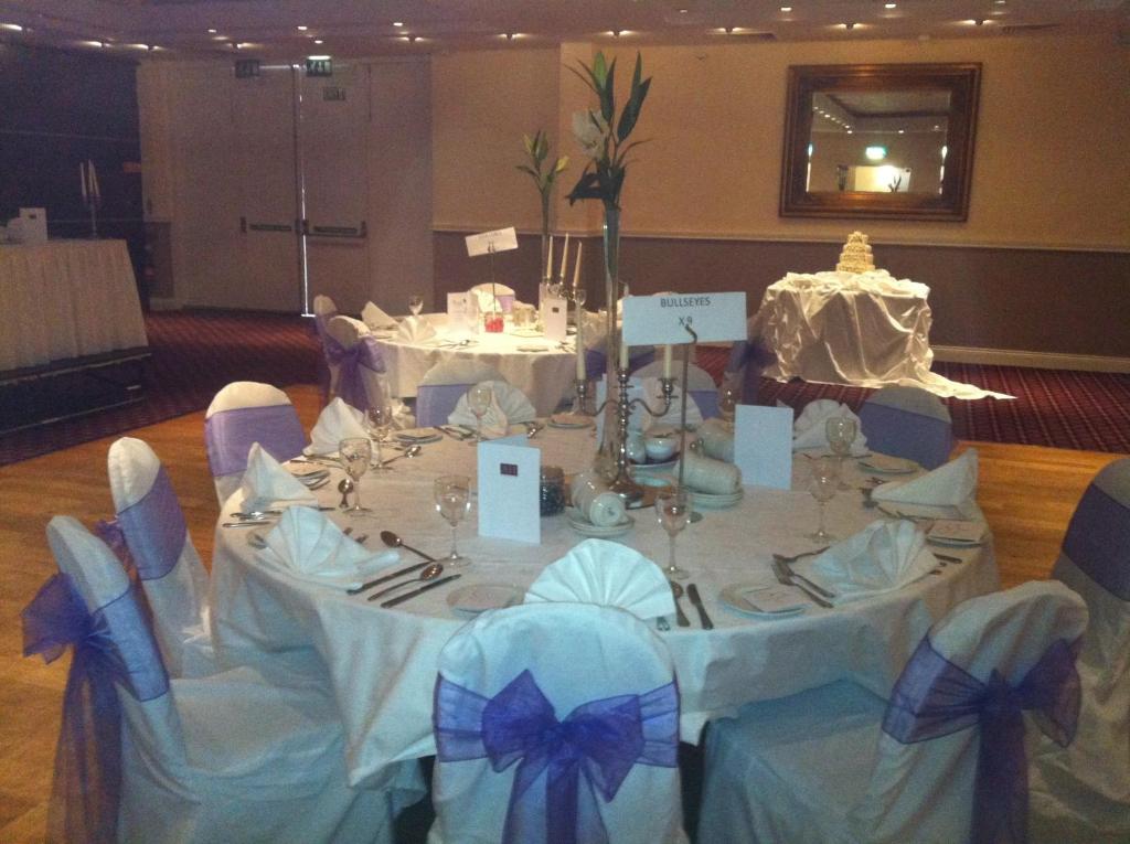 a table in a room with a white table with blue bows at Ashbourne House Hotel in Ashbourne
