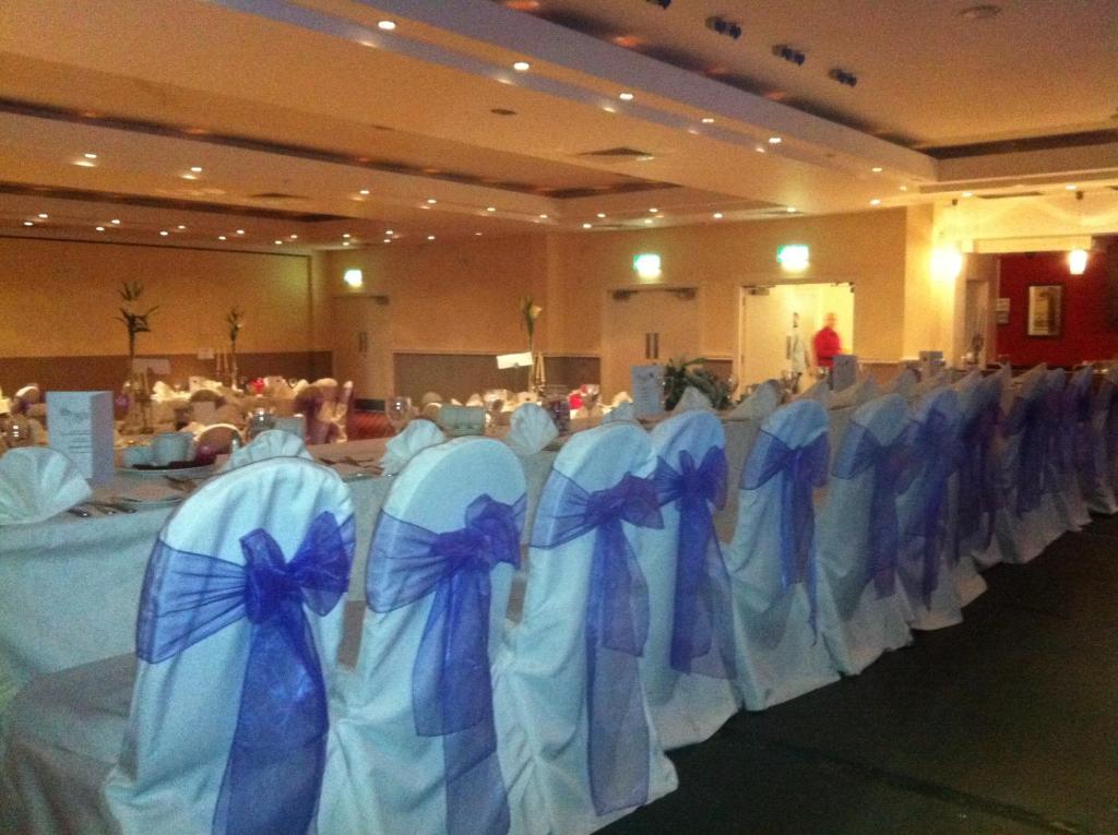 a row of blue and white chairs in a room at Ashbourne House Hotel in Ashbourne