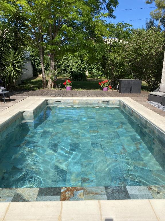 une piscine avec de l'eau bleue dans une cour dans l'établissement Villa Mathi, à Marseille