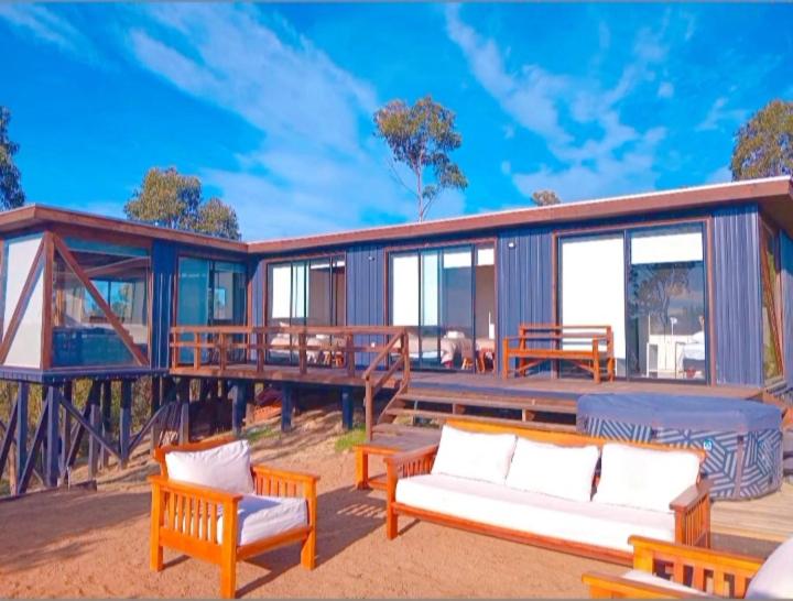 a house with two couches on a deck at Soul House- Colinas y Mar in Navidad