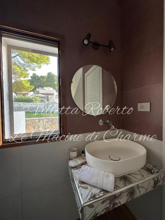 a bathroom with a sink and a mirror at Villetta Roberto Le Macine di Charme - Pugnochiuso Resort in Vieste
