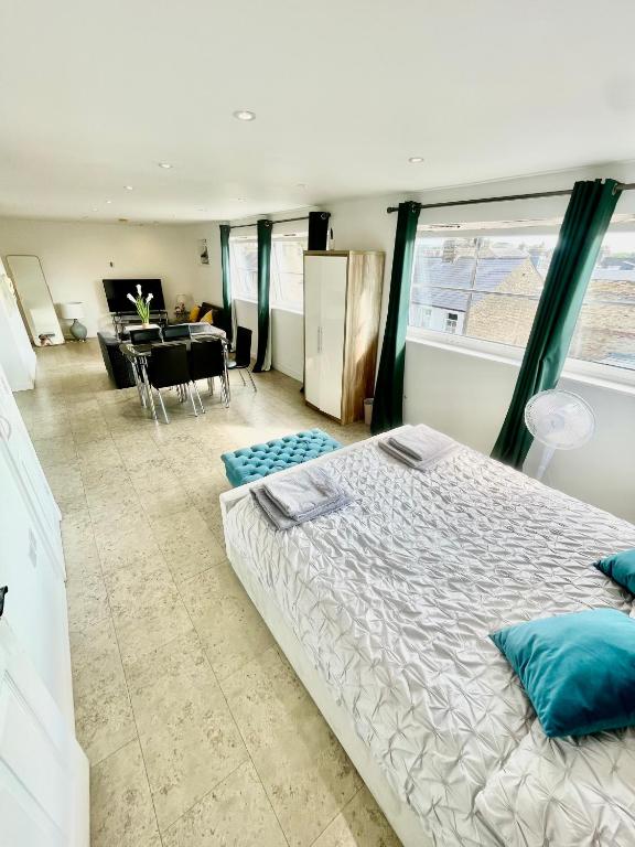 a bedroom with a large bed and a dining room at City Centre Cozy Studio flat Second Floor in Cambridge