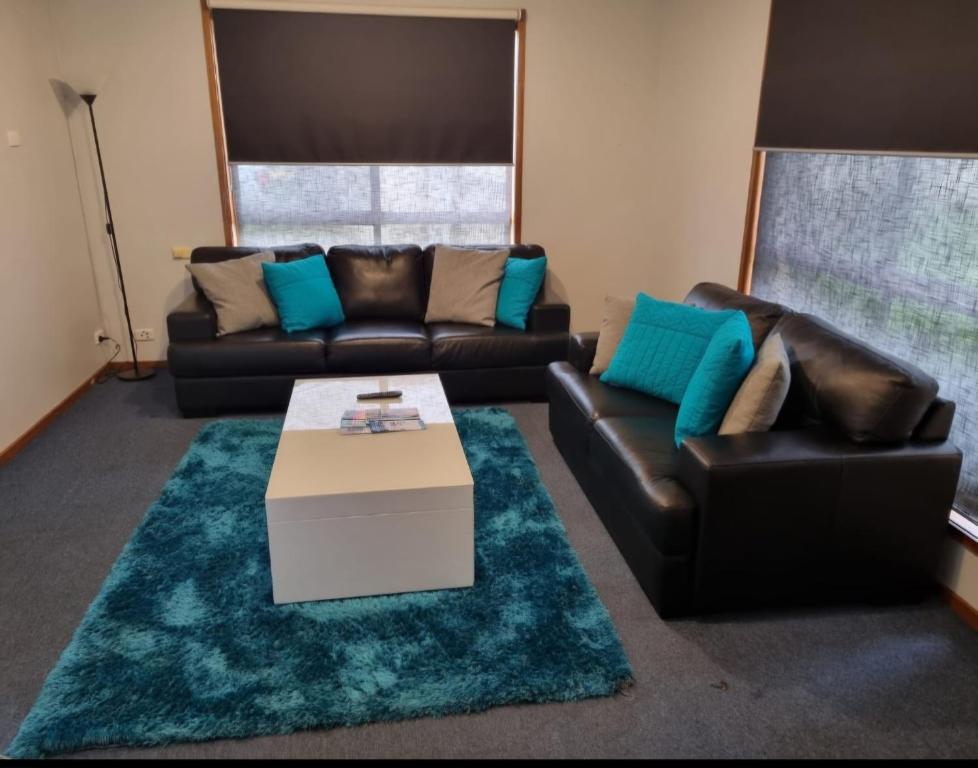 a living room with a couch and a coffee table at WI -FI- Netflix- Super Comfiest 3 Bedroom Home With Massive 21Metre Driveway Space for boat & Caravan in Portland
