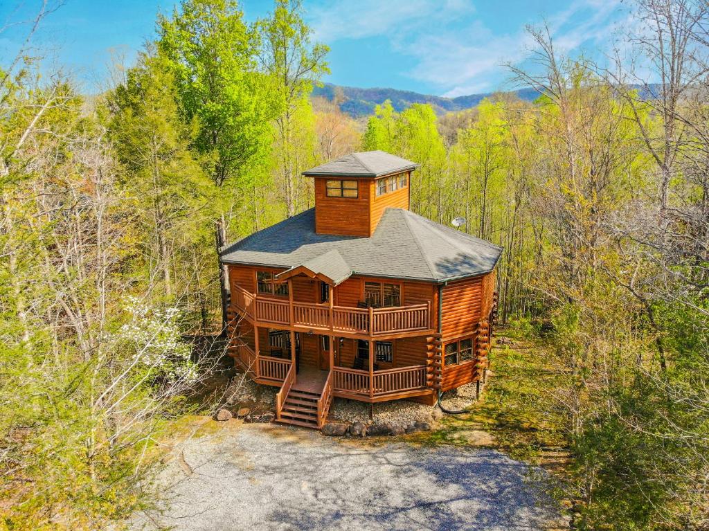 a large wooden cabin in the middle of a forest at Indoor Pool Beauty in Cosby